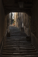 Fototapeta na wymiar Beautiful street of captivating medieval town of Cortona in Tuscany, Italy. It is an ancient Etruscan hill town, full of narrow steep streets, intimate piazzas, stunning artwork and historical museums