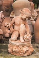 Fototapeta na wymiar cstatue of nude young girl kneeling, in Impruneta, Italy.