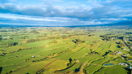 Aerial view on a farmland with stock paddocks at the foot of Mount Taranaki. Taranaki region, New Zealand