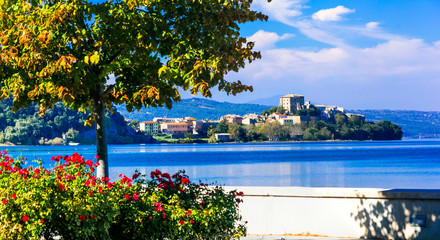 Scenic lake Bolsena (lago di Bolsena) with view of medieval borgo Capodimonte. Italy, Viterbo province - obrazy, fototapety, plakaty