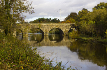 Fototapeta na wymiar The ancient stone built Shaw's Bridge over the River Lagan close to the little mill village of Edenderry on the outskirts of South Belfast in Northern Ireland