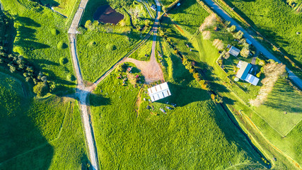 Aerial view on a farmland with roads and small houses. Taranaki region, New Zealand