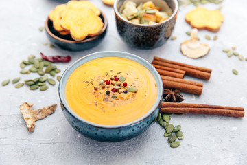 Bowl with fresh homemade sweet potato pumpkin soup and spices.