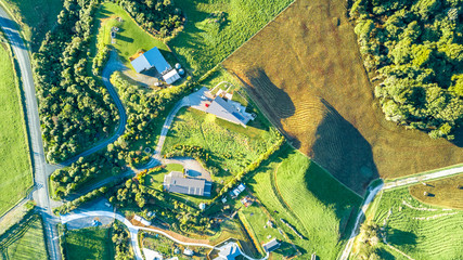 Aerial view on a farmland with roads and small houses. Taranaki region, New Zealand