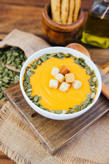 bowl of delicious pumpkin soup with decorations