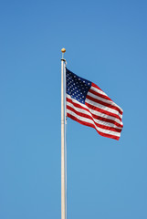 Waving USA flag at flag pole 