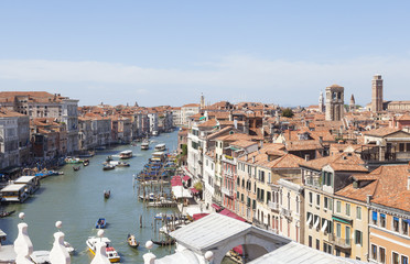 Fototapeta na wymiar Rooftop view of the Rialto area of the Grand Canal, Venice, Italy with busy boat traffic including gondolas