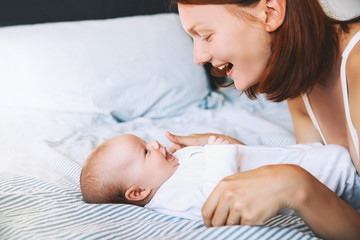 Beautiful mother and cute baby child at home