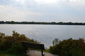 Fototapeta na wymiar Bench on the lake shoreline
