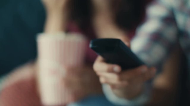 Close up an hand with TV remote changing channels and volume increase electronics holding home interior isolated modern multimedia press program programming Shot on RED EPIC camera. Slow Motion Shot