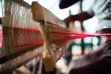 weaving red scarf on loom