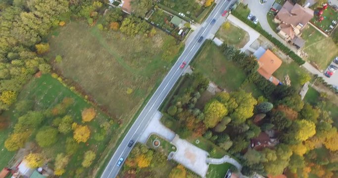 Aerial flight over road at mountain village in autumn – 4k Footage