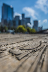 Extreme Close up of Wood Plank on Pier City Downtown in Background Blue Sky White Clouds