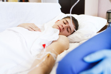 A nurse injects a patient with a vein