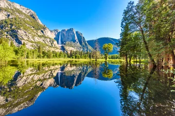 Fotobehang Yosemite National Park - Reflection in Merced River of Yosemite waterfall and beautiful mountain landscape, California, USA © Simon Dannhauer