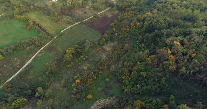 Aerial flight over autumn forest with way – 4k Footage