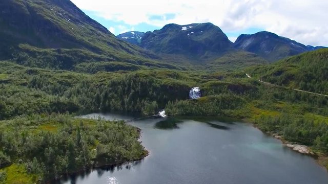 Aerial view of clear lake and waterfall on a mountain pass Gaularfjellet in Norway