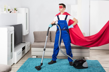 Janitor Cleaning Carpet With Vacuum Cleaner