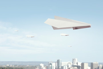 Fototapeta premium Origami plane flying in sky. Mixed media