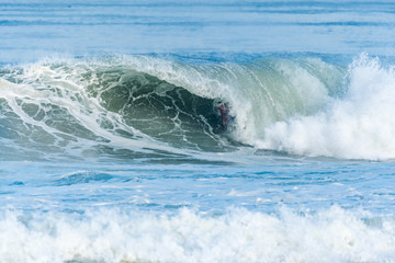 Bodyboarder surfing ocean wave