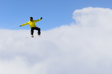 Fototapeta na wymiar Snowboarder making jump