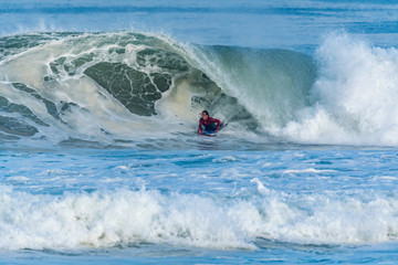 Bodyboarder surfing ocean wave