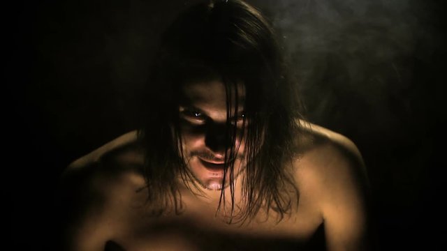 In a dark room, a devil settles into a man HD
