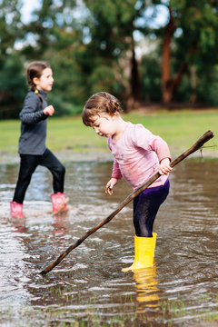 Girls in a Big Brown Puddle