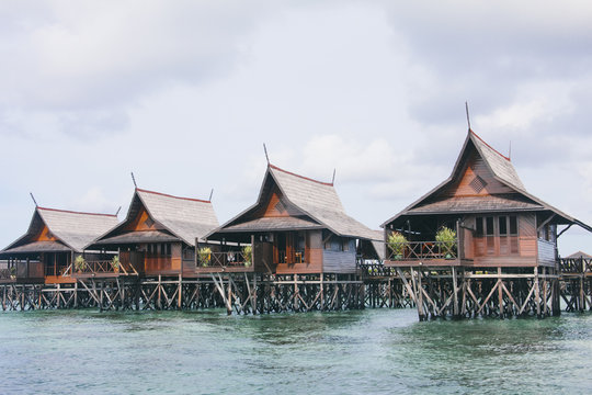 Resort over water bungalows on the sea on exotic tropical island