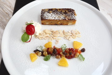 Fruitcake on white plate and decorative topping, American Style Luxury Restuarant