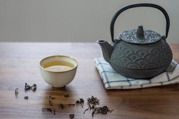 Image of traditional eastern teapot and teacups on wooden desk 