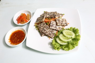 Vietnamese Food in Restaurant white plate on the Table with side dish, Spring rolls with vegetables and in noodle tube pork tao fu inside