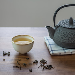 Image of traditional eastern teapot and teacups on wooden desk 