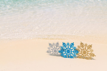 Christmas tree decorations on sea beach sand - winter holidays in tropics, Xmas festive concept
