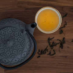 Image of traditional eastern teapot and teacups on wooden desk 