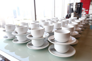Group of empty coffee cups.Many rows of white cup for service tea or coffee in breakfast or buffet and seminar event. white cup in Catering and Cocktail.