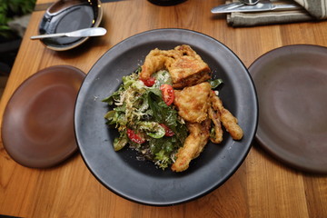 Soft shell crab Deep Fried Salad one body and slice half on wooden table and lamp