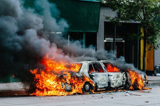 Police car burning in fire on street