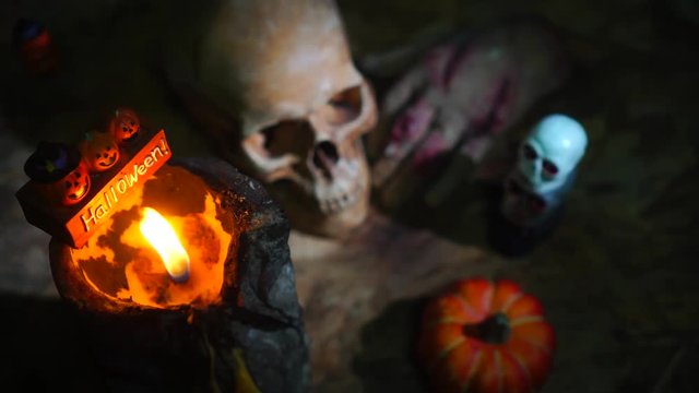 Halloween day footage with skull, pumpkin, candle light, and movement