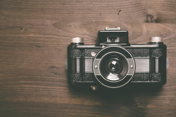 Analog camera on wooden background