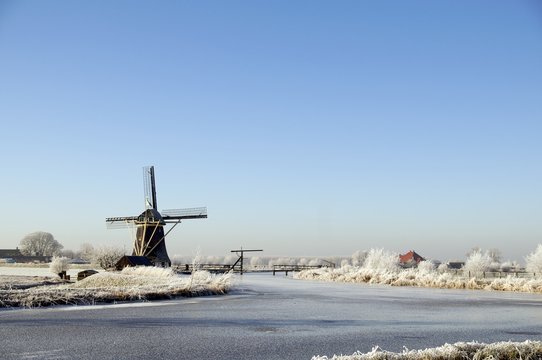 Winter landscape with mill