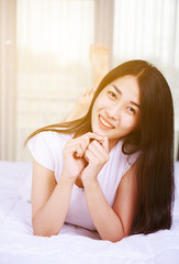 portrait beautiful woman on bed in bedroom