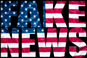 fake news in bold letters with american flag background  - 178295028