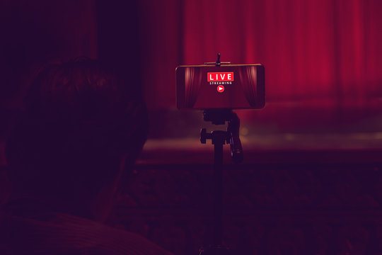 Smartphone On Tripod Wait For Video Live Streaming In Theater, Technology Social Concept