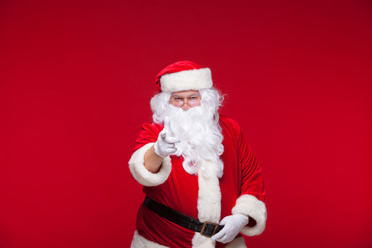 Santa Claus is dancing Isolated on red background.