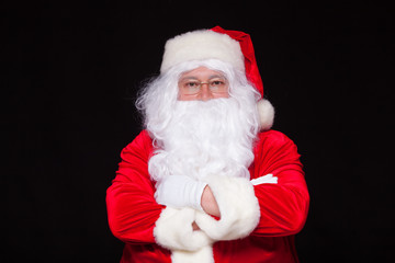 Christmas. Santa Claus portrait smiling against black background.