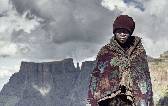 A Portrait Of A Black Basotho Shepherd Wrapped In A Traditional Blanket.