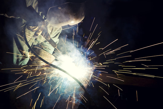 Metal Worker Soldering Metal With Sparks