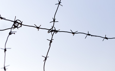 barbed wire on blue sky background
