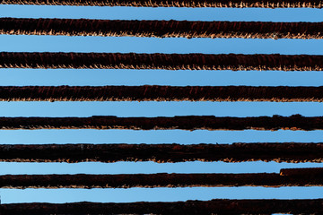 the old iron bars on blue sky background